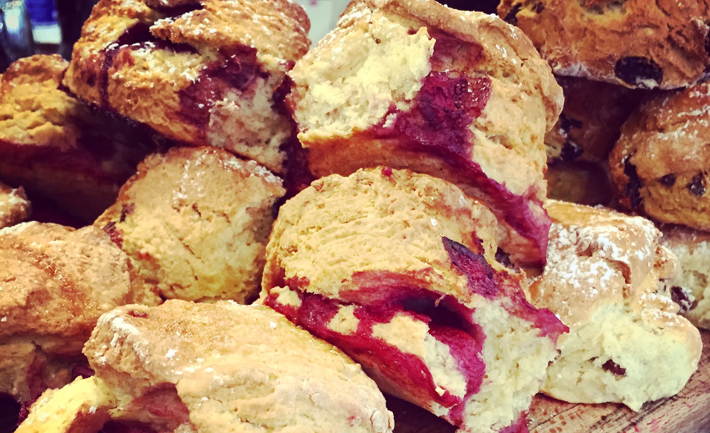 Picture of multiple scones with raspberries oozing out of them